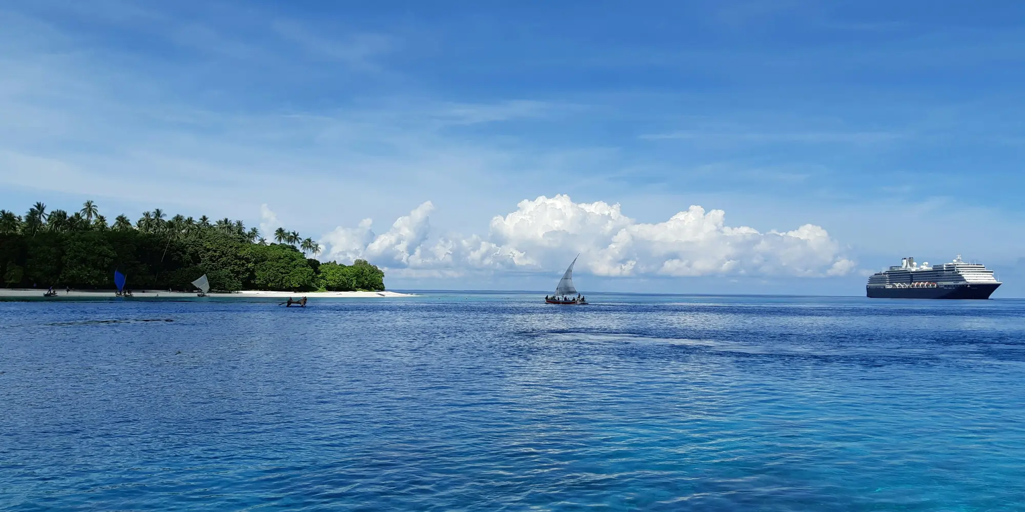 Ilha no mar na Papua-Nova Guiné com catamarã e navio de cruzeiro